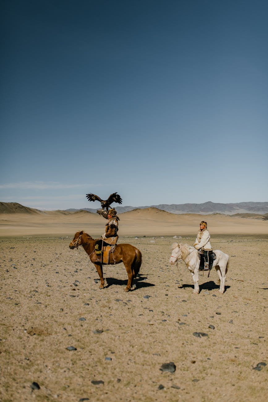 Traditional nomadic yurt settlement in vast steppe landscape with local families welcoming visitors